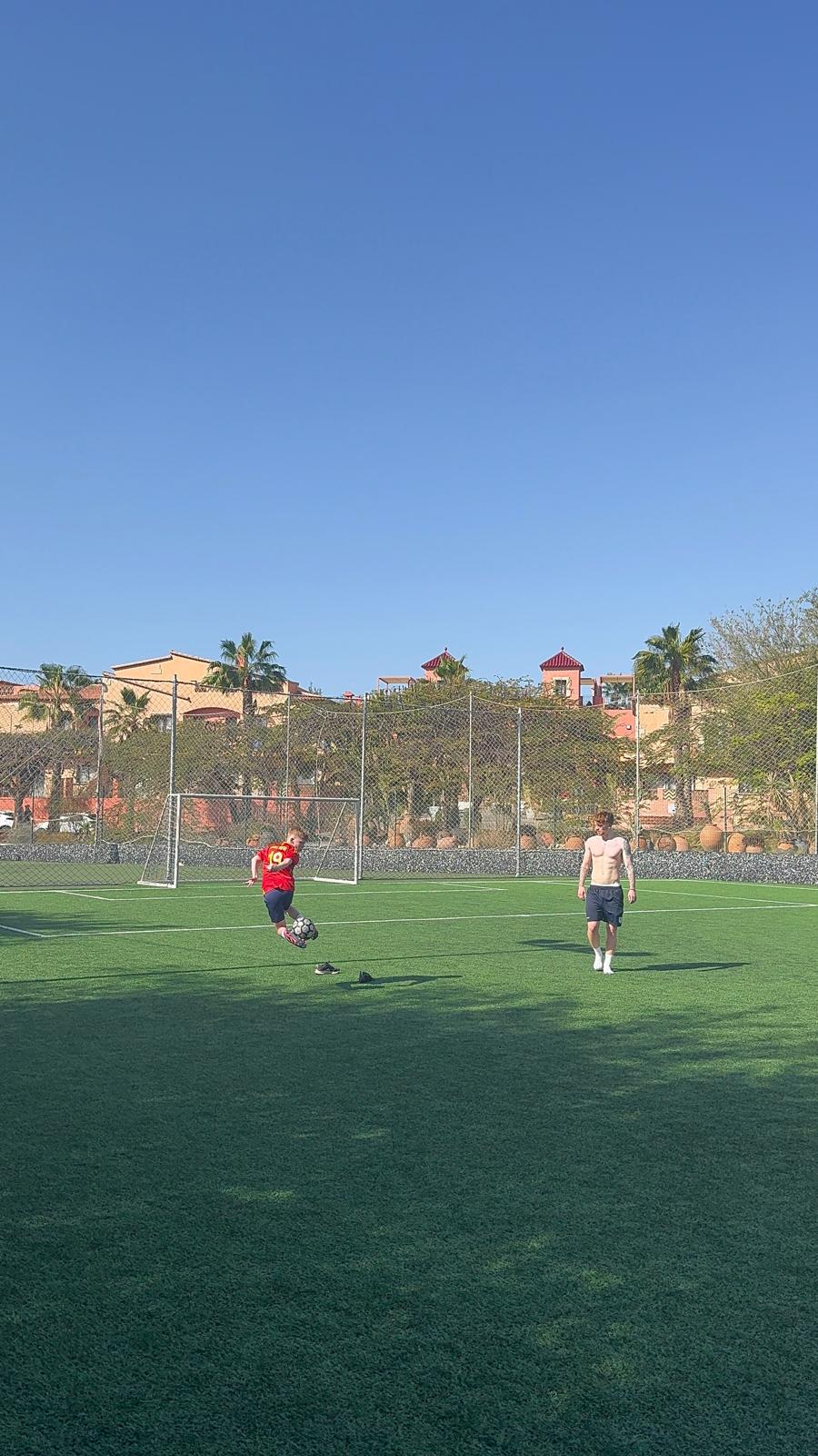 Ace Online coach training a young player on the pitch